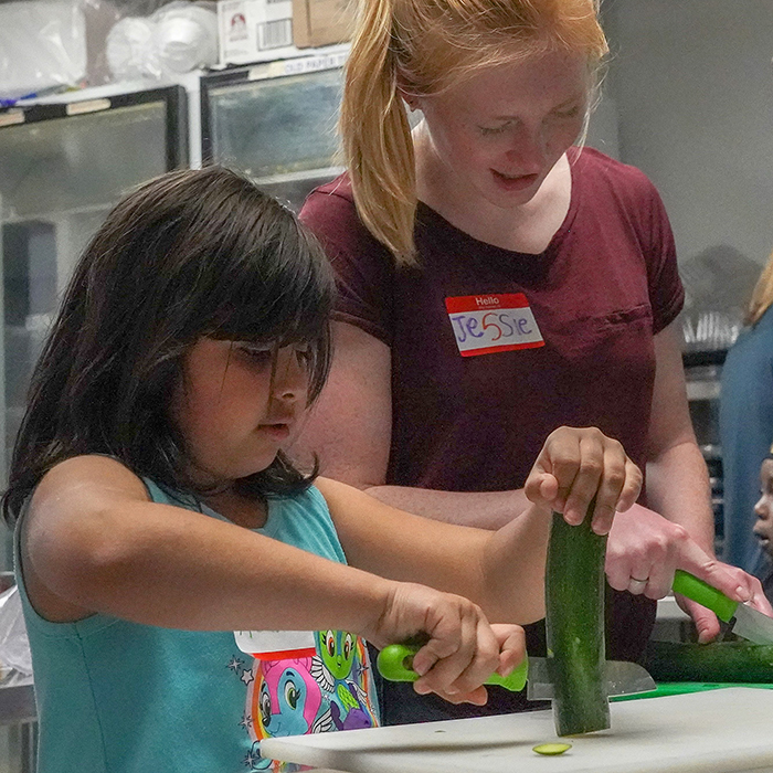 volunteer teaching kids to cook