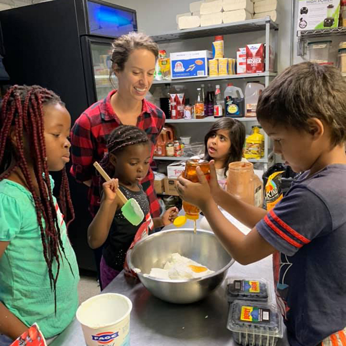 volunteer teaching kids to cook